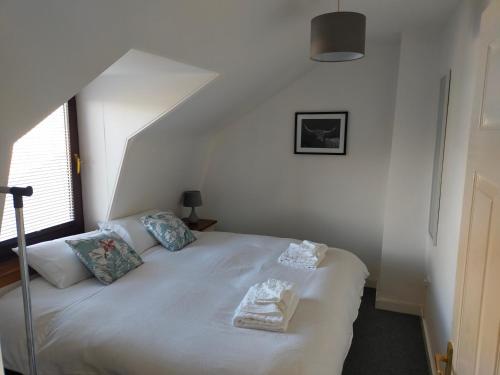 een slaapkamer met een bed met twee handdoeken erop bij The Loft, Inverness in Inverness