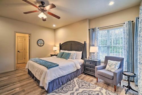 a bedroom with a bed and a chair and a ceiling fan at Branson West Villa w/ Golf Course View & Pool! in Branson West