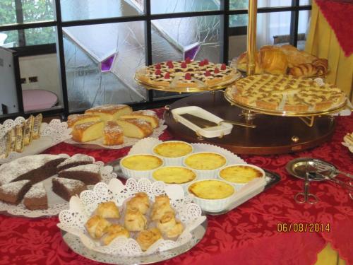 a table with many different types of bread and pastries at Hotel Matilde in Marina di Massa