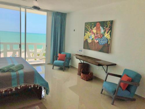 a bedroom with a bed and a table and chairs at Playa 55 beach escape - adults only Guesthouse in Celestún