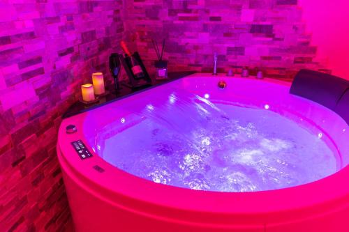 a hot tub with pink lighting in a bathroom at Silver Suite Coliseum in Rome