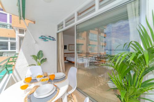a dining room with a table and chairs on a balcony at Ocean Views in Punta del Hidalgo