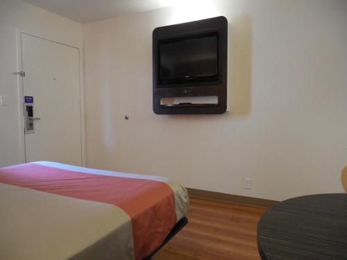 a room with a bed and a tv on the wall at Motel 6-Temecula, CA - Historic Old Town in Temecula