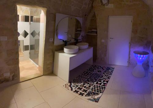 a bathroom with a sink and a mirror at L’INFANZIA HOLIDAY HOME in Bari