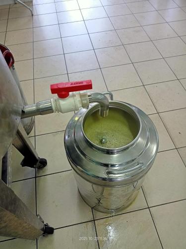 a metal bucket with a green liquid in it at La Torre di Barbara in Ardea
