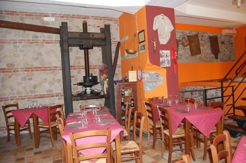 a restaurant with tables and chairs in a room at Agriturismo Parra in Santa Lucia del Mela