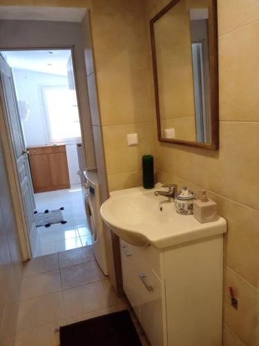 a bathroom with a sink and a mirror at La Casa del Sol in Keramídhion