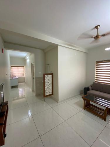 a living room with a couch and a table at Nimet Residency in Ernakulam