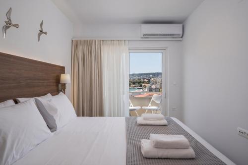 a bedroom with a bed with two towels on it at Urban Residences Chania in Chania Town
