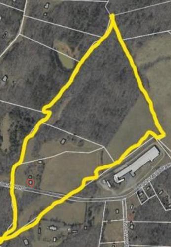 a yellow line on a field with a parking lot at Giggling Creek Cottage - BedJet! King Sized! Gazebo, 45 Acres, Arcades, Nintendo, more in Henry