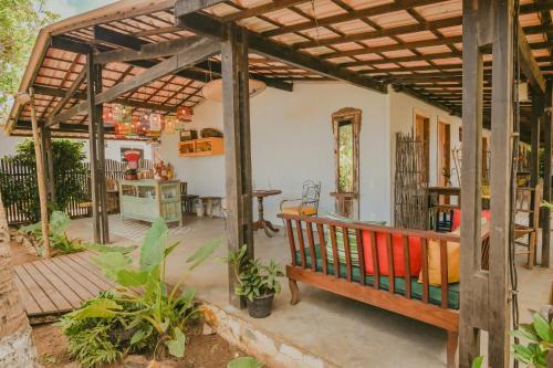 a patio with a wooden pergola in a house at EcoCharme Pousada Netuno in Fernando de Noronha