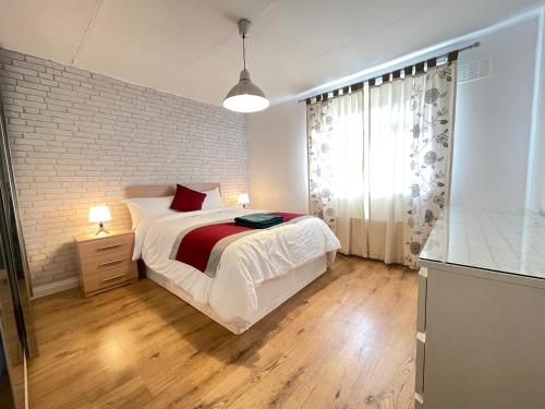 a bedroom with a bed and a brick wall at Durham Eastside Professional Let - Durham city in Ushaw Moor