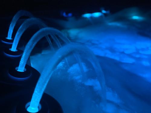 a close up of a water fountain in the dark at Zengő Kincse SPA Vendégház Hosszúhetény in Hosszúhétény