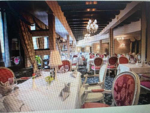 a dining room with a bunch of chairs and tables at Alpin Apart Hotel Poiana Brasov2409 in Braşov