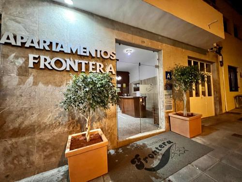 a store front with two potted trees in front of it at Apartamentos Frontera in Frontera