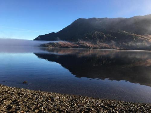 a body of water with a mountain in the background at Bayfield in Lamplugh