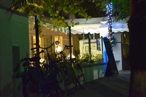 two bikes parked next to a fence at night at Petit Hotel in Lido di Camaiore