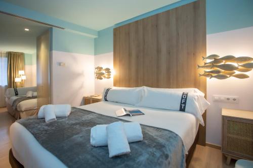 a hotel room with a large bed with two books on it at Casual Colours Barcelona in Barcelona