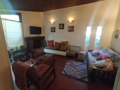 sala de estar con sofá y TV en Casa Cuatro Robles en Mar del Plata