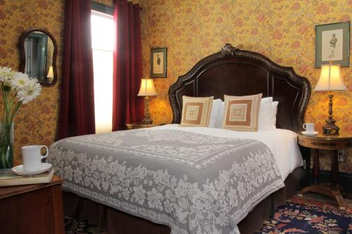 a bedroom with a large bed and a mirror at Monte Cristo Bed and Breakfast in San Francisco
