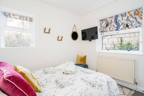 a white bedroom with a bed and a window at BRAND NEW LSITING!Wonderful One Bedroom Apartment in Bath