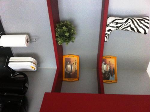 a mirror in a room with pictures on the wall at Gästehaus Waldmohr in Waldmohr