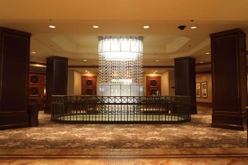 a lobby with a chandelier in the middle of a building at The Yorkville Royal Sonesta Hotel Toronto in Toronto