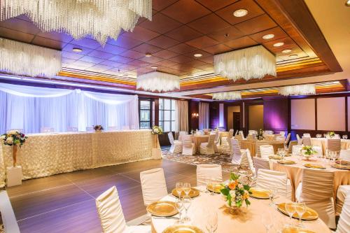 a banquet hall with white tables and chairs and chandeliers at The Yorkville Royal Sonesta Hotel Toronto in Toronto