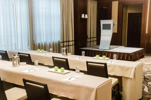 a group of tables in a room with a television at The Yorkville Royal Sonesta Hotel Toronto in Toronto