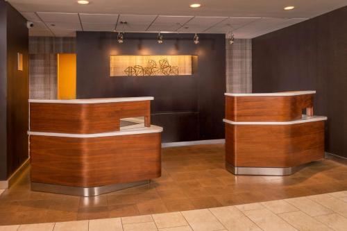 a lobby with wooden counters and a painting on the wall at Sonesta Select Arlington Rosslyn in Arlington