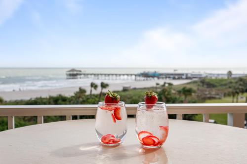 two cocktails on a table with a view of the beach at Cocoa Beach Towers in Cocoa Beach