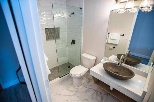 a bathroom with a sink and a toilet and a shower at The Shore Club in Spring Lake Heights