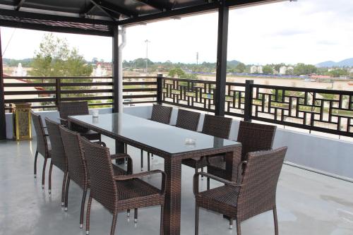 a table and chairs on the roof of a building at Hotel Decentraland Kuala Terengganu in Kuala Terengganu