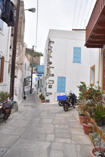 an alley with motorcycles parked next to a building at Patriko Nisyrian Guesthouse in Mandrakion