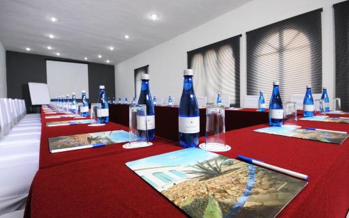 a row of tables with bottles of wine on them at Hotel & Spa Hacienda Baruk in Zacatecas