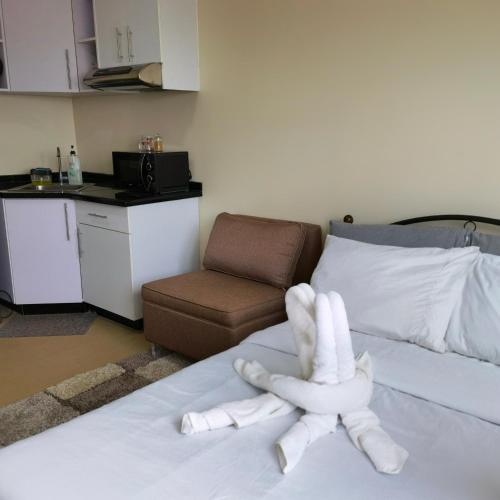 a pair of white gloves sitting on top of a bed at Avida Davao by davaobnb & Lemonique Homes in Davao City