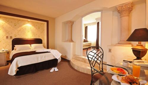 
Ein Bett oder Betten in einem Zimmer der Unterkunft Hotel & Spa Hacienda Baruk
