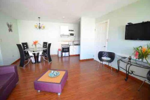 a living room with a couch and a table at Caribbean Villages Aparments in Bocas del Toro