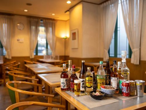 a table with many bottles of alcohol on it at Hotel Dorf Shizuoka in Shizuoka