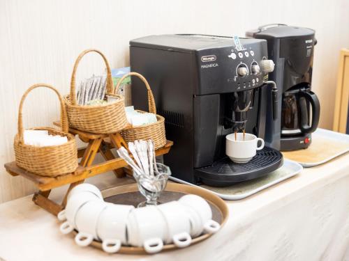 a coffee maker and baskets on a counter at Hotel Dorf Shizuoka in Shizuoka