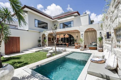 a house with a swimming pool in the yard at Casa 88 Berawa in Canggu