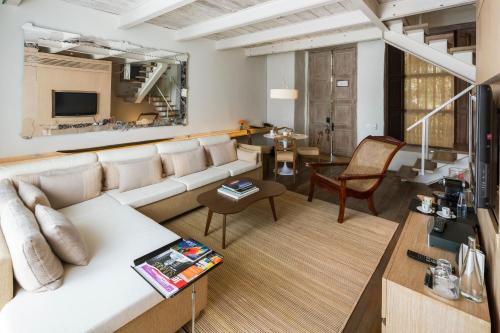 a living room with a couch and a table at Sofitel Legend Santa Clara Cartagena in Cartagena de Indias