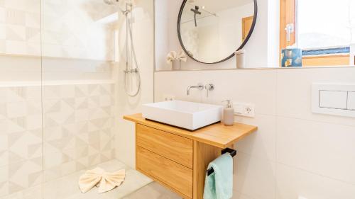 a bathroom with a sink and a mirror at Chalet im Winkl in Reit im Winkl
