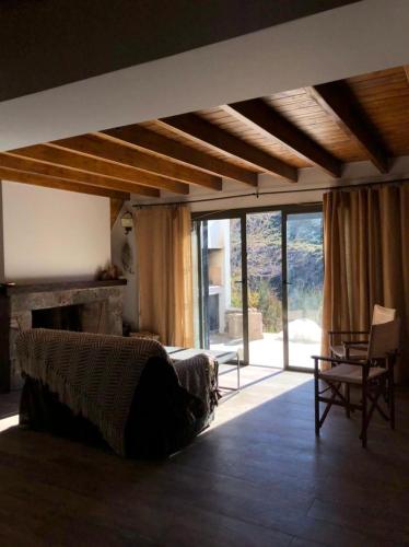 a living room with a bed and a fireplace at Casa El Ciprés in Potrerillos