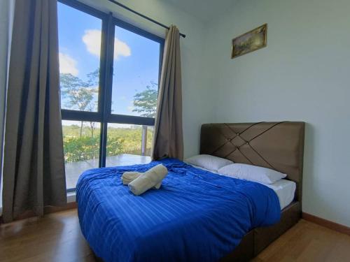 a bedroom with a blue bed with a large window at The clio 2 residences, beside conezion, beside ioi city mall, opposite serdang hospital, beside uniteen and UPM, Putrajaya in Putrajaya