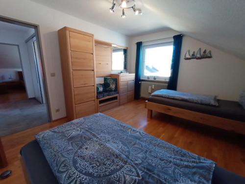 a bedroom with a bed and a dresser at BodenSEE Apartment Langenargen Möwenweg in Langenargen