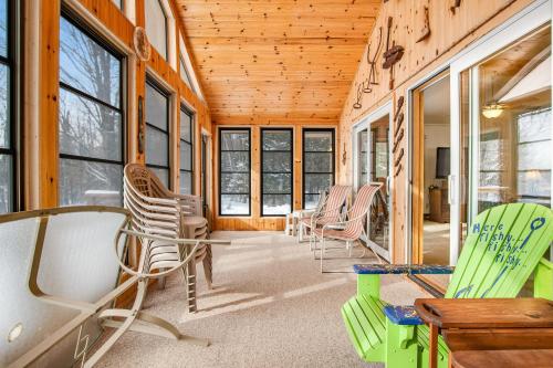a room with chairs and tables and windows at The Loony Bin in Manitowish Waters