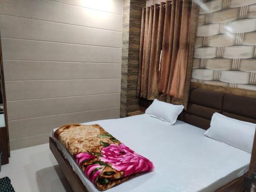 a bedroom with a bed with white sheets at Hotel Al Sharif Manzil 90 Mtrs from Dargah in Ajmer