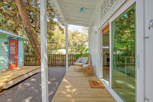 a porch of a house with a glass door at The Other Place Cottage C in Folly Beach