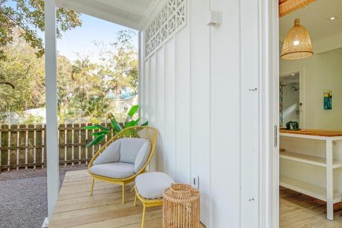 a porch with a chair and a table at The Other Place Cottage C in Folly Beach
